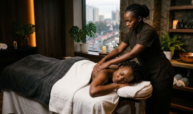 A woman receives a shoulder massage in a warmly lit Nairobi spa.